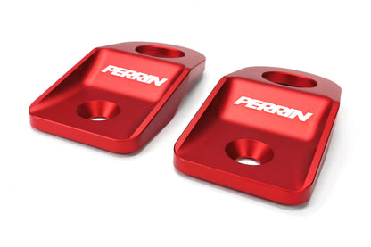 Red aluminum radiator stays for 2008-2014 Subaru WRX, STI, Impreza, and Outback, enhancing engine stability and performance.